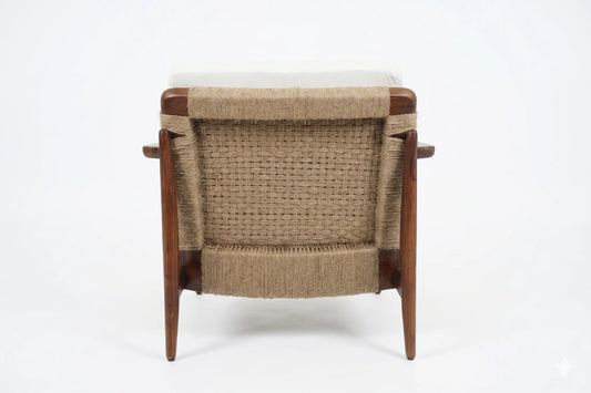 A mid-century modern wooden armchair viewed from the back, featuring a woven natural-fiber seat and backrest with a light beige cushion on a white background.