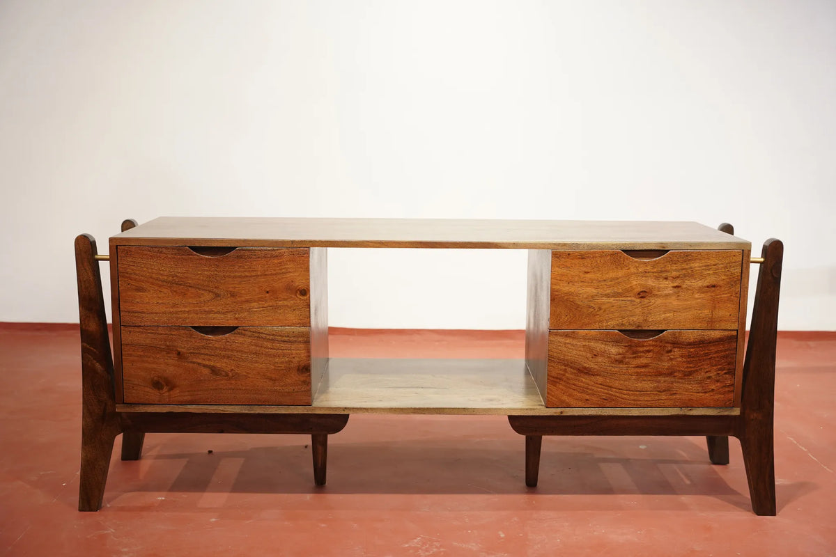Mid-century modern wooden console table with two drawers on each side, an open center shelf, and tapered legs, shown against a plain white wall and terracotta-colored floor.