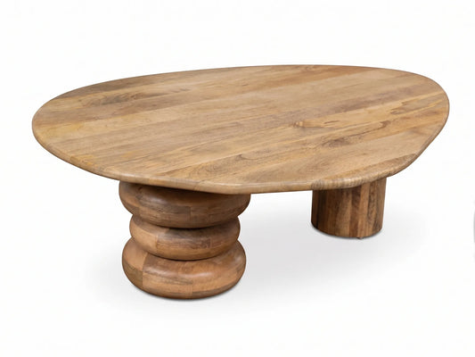 An organic-shaped wooden coffee table with a warm medium-brown finish, featuring a thick round top and a stacked-ring pedestal base on a white background.
