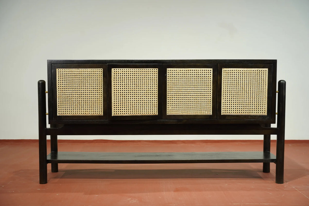 A modern wooden bench with a dark brown frame and four woven cane panels on the back, set against a plain light gray wall and terracotta-colored floor.