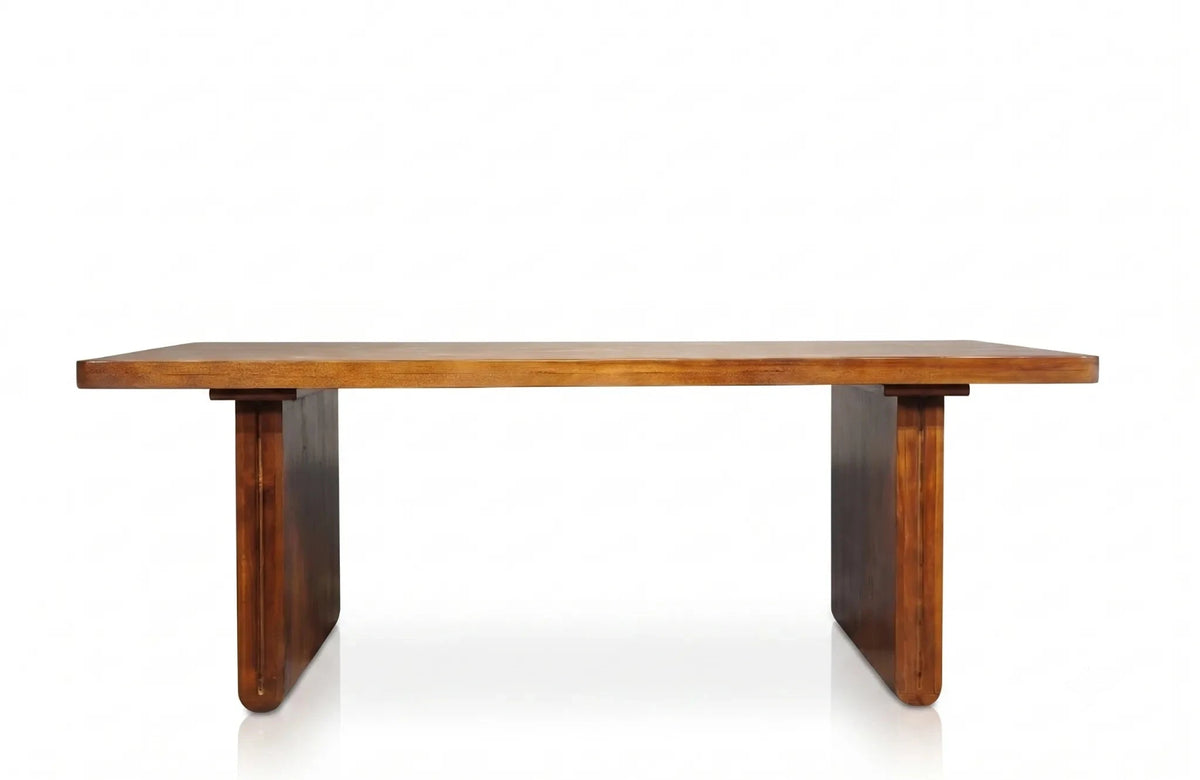 A mid-century modern wooden dining table with a warm medium-brown finish, featuring thick rectangular legs with rounded ends, shown against a plain white background.