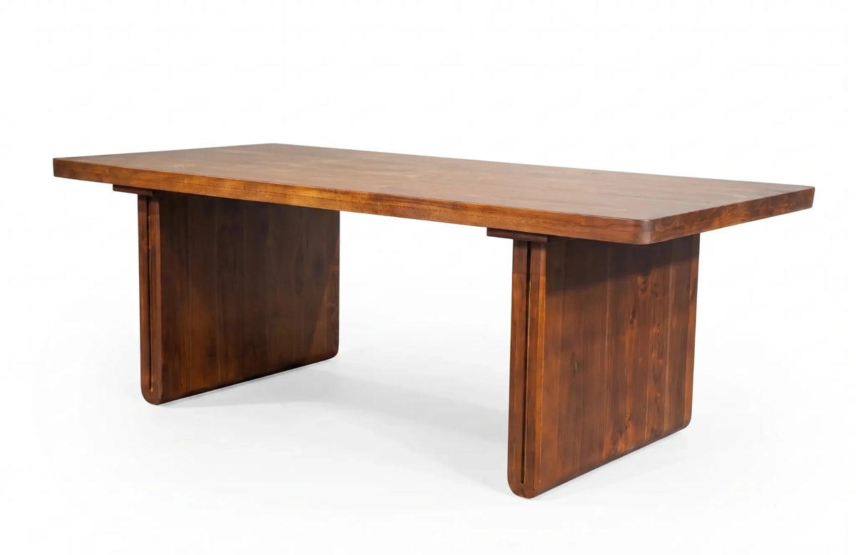 A mid-century modern wooden writing desk with a rectangular top and blocky pedestal legs, shown on a white background.
