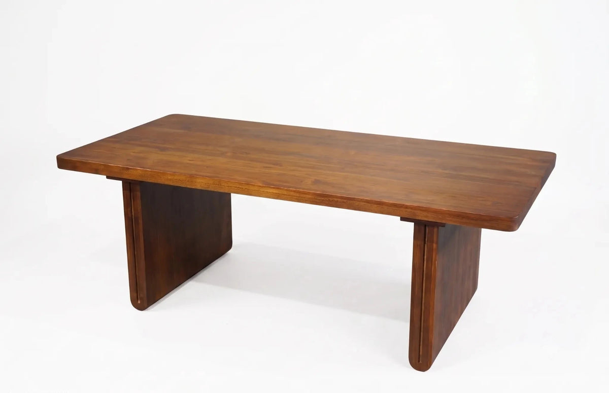 A mid-century modern wooden table with a rectangular top and block-style legs, shown on a clean white background.