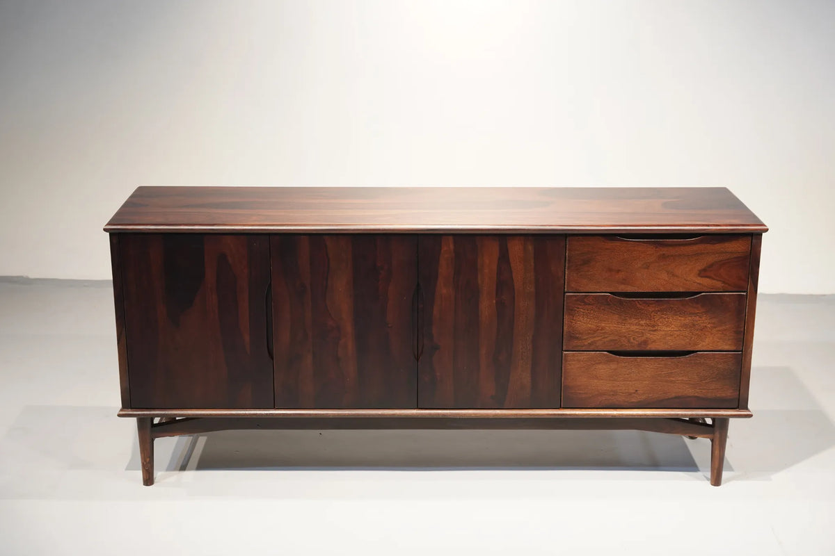 Mid-century modern wooden sideboard with a dark walnut finish, featuring three cabinet doors on the left and three drawers on the right, supported by angled legs.