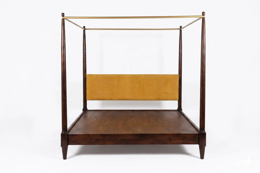 A mid-century modern canopy bed frame made of dark brown wood with a mustard yellow upholstered headboard and brass metal canopy bars, shown against a plain white background.