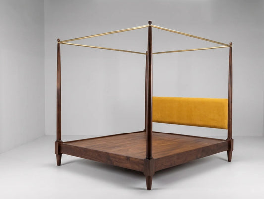 A mid-century modern four-poster canopy bed with a dark walnut wood frame, a yellow velvet upholstered headboard, and a brass canopy frame, shown in a minimalist studio setting.