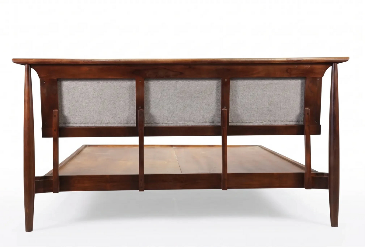 A mid-century modern wooden console table with a dark brown finish, featuring three upholstered backrests with gray fabric and a lower shelf, shown against a white background.